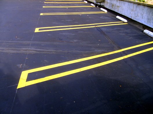 A parking lot. I modified the colors to make the photo slightly more vivid than the dull parking lot. I like how the yellow marks line up nicely with interesting angles.