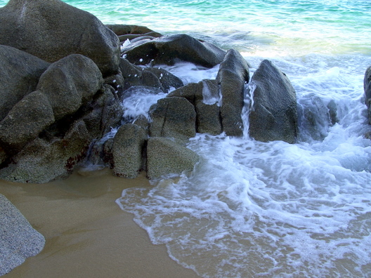 A wave splashing over rocks